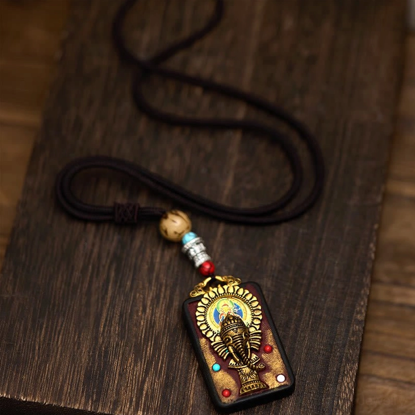 Buddhist Ganesha elephant pendant necklace artistic angle showing spiritual symbolism
