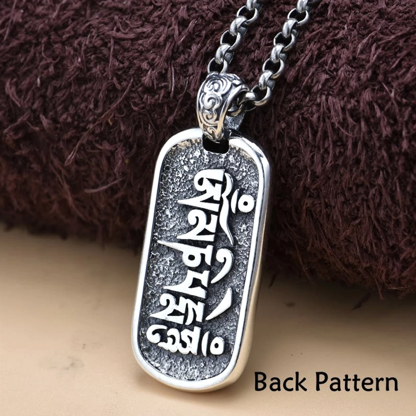 Reverse side of sterling silver Buddhist pendant showing full Sanskrit mantra engraving and back pattern details
