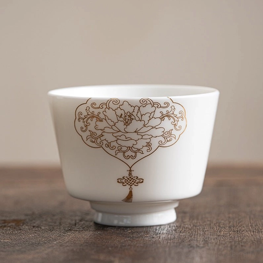 Artisan-made Buddhist porcelain tea cup featuring golden peony design representing prosperity and spiritual blessings