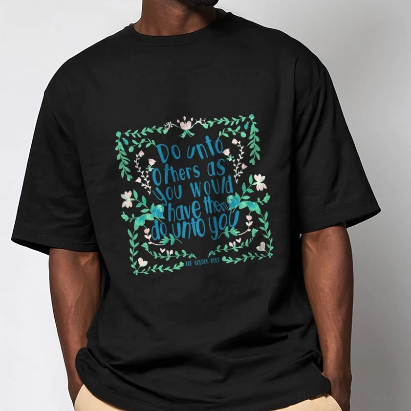 Man in black Buddhist graphic tee featuring golden rule spiritual print three-quarter front view neutral background