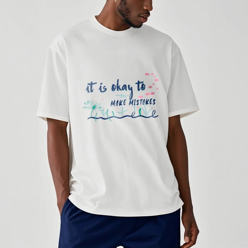 Male model wearing off-white Buddhist mindfulness tee with dark blue trousers studio shot