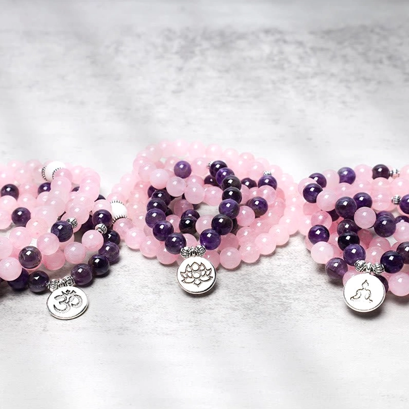 Multiple Buddhist mala bracelets with rose quartz, amethyst and spiritual pendant charms