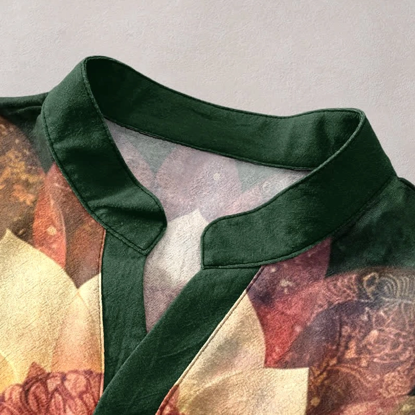 Close-up detail of dark green stand collar with stand collar neckline and printed lotus pattern on Buddhist henley shirt