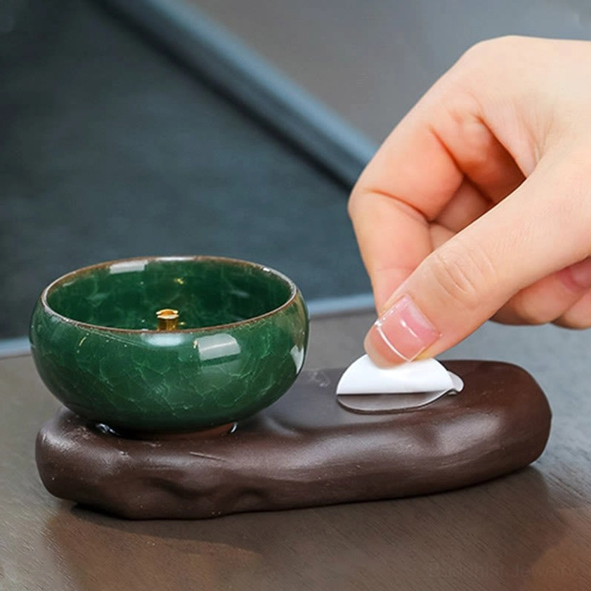 Incense burner component details showing separated green ceramic bowl and brown stone-shaped ceramic base with attachment instructions