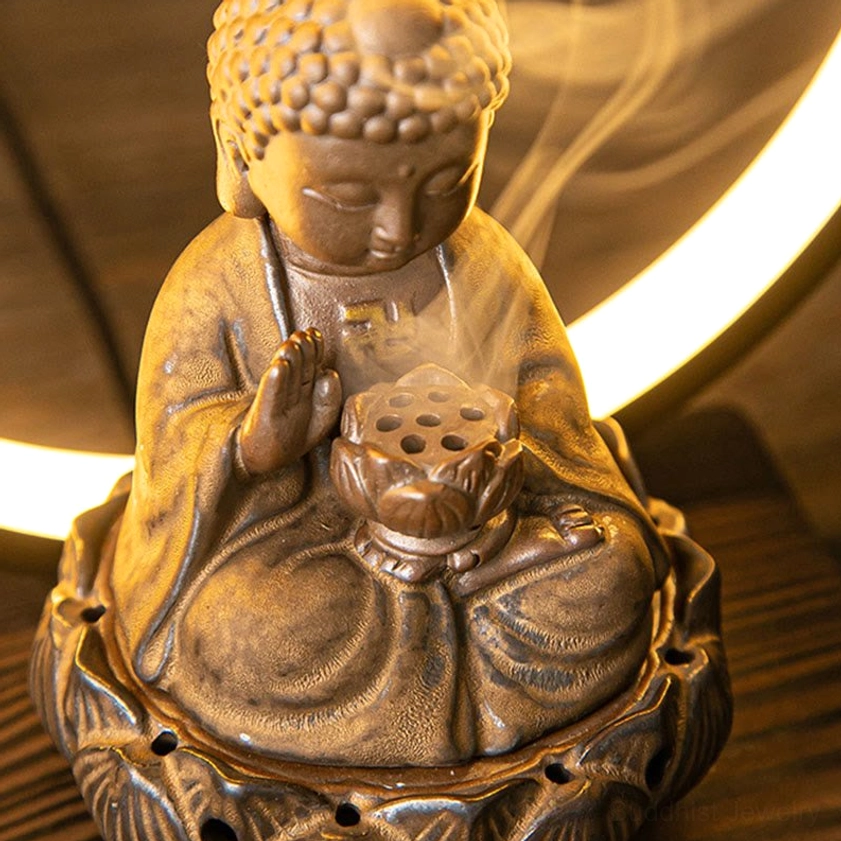 Buddhist backflow incense burner with warm LED lighting creating peaceful spiritual ambiance for mindfulness