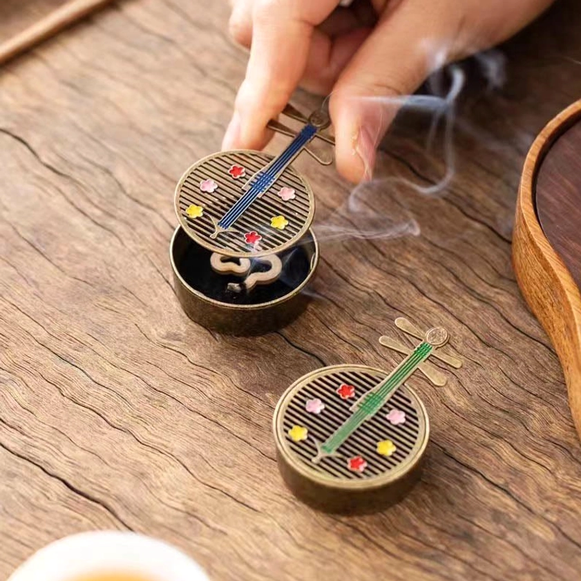 Buddhist incense burner lifestyle image showing meditation and spiritual wellness practice setup
