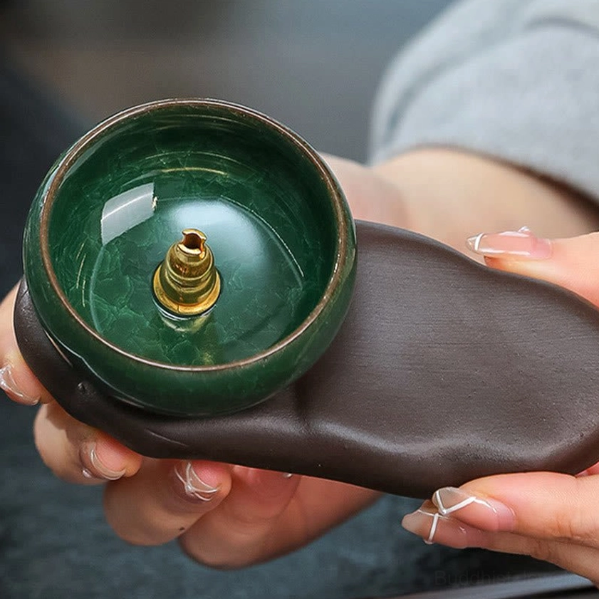 Ceramic incense burner overhead view displaying metal incense holder inside green glazed bowl with brown stone-like ceramic base