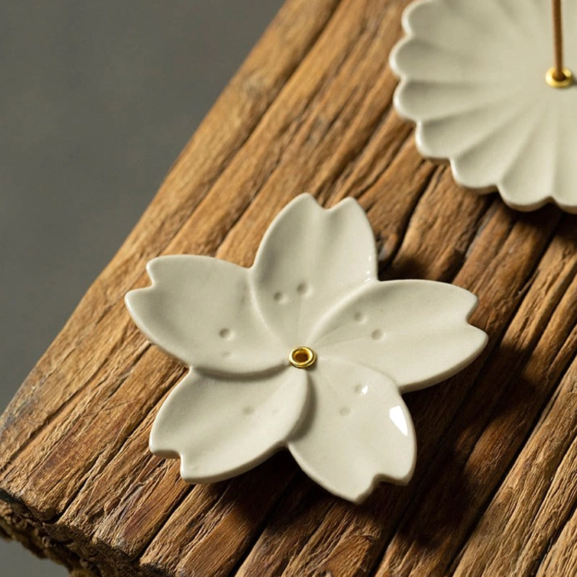 Buddhist ceramic incense burners collection showing cherry blossom and chrysanthemum styles side by side