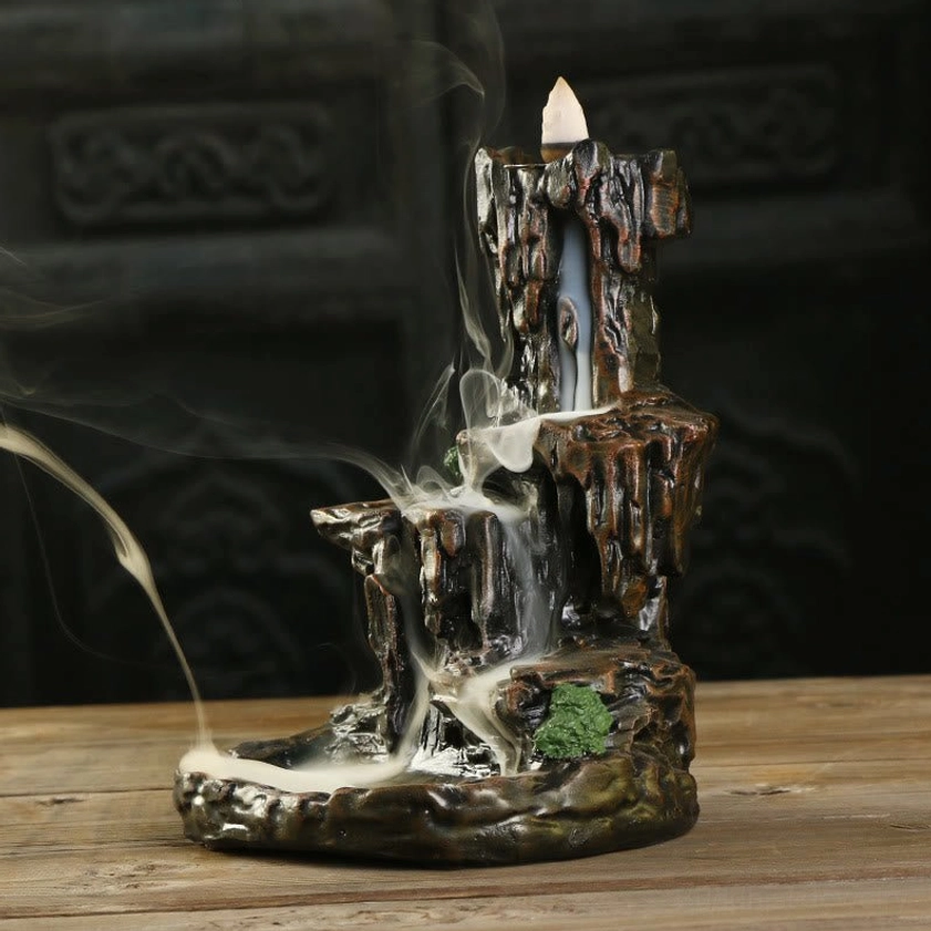 Backflow incense burner with waterfall smoke effect, Buddhist mountain tower holder, side angle view with flowing smoke cascade