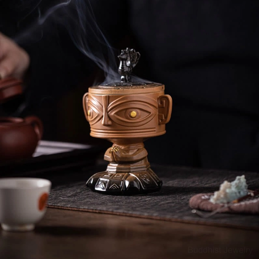 Ancient-inspired ceramic incense holder on traditional tea table with teacup and decorative ornaments, smoking