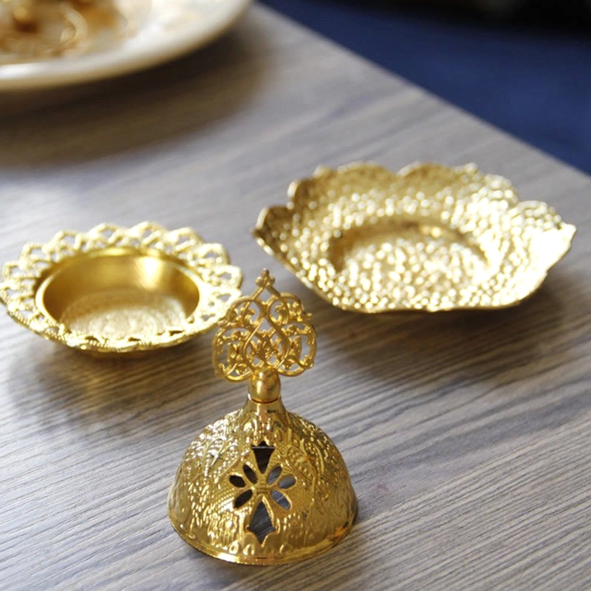 Complete Buddhist incense burner accessory set showing three golden components with floral embossed surface