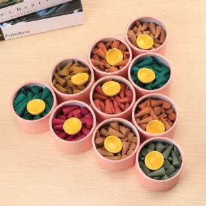 Buddhist incense cones collection set with multiple scents in pink storage boxes, flat lay view