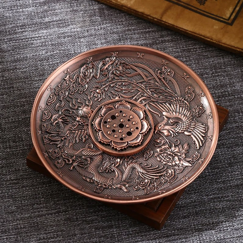 Dragon and phoenix Buddhist incense holder in red copper finish with detailed carved motifs and incense holes