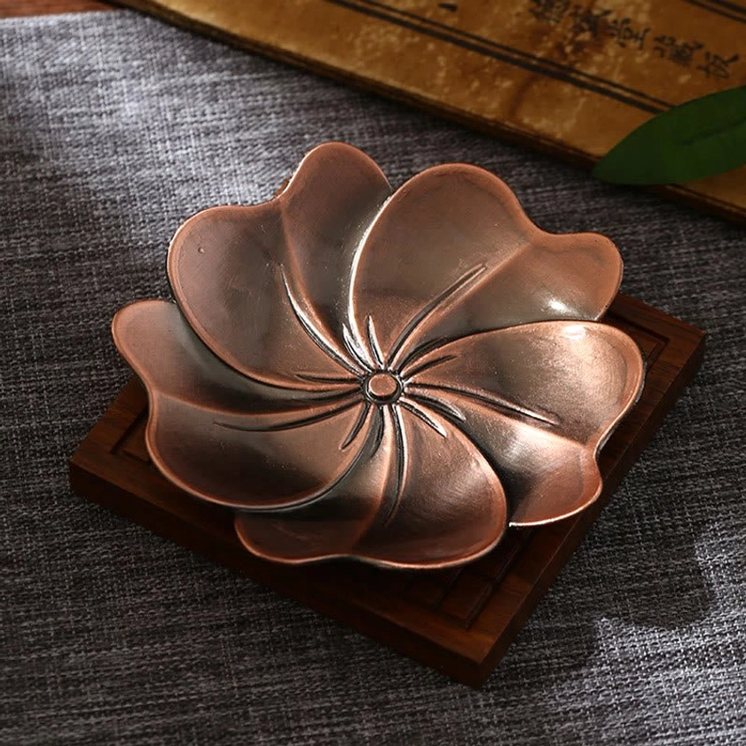 Lotus design Buddhist incense burner in brown finish, overhead tabletop view with carved lotus motif