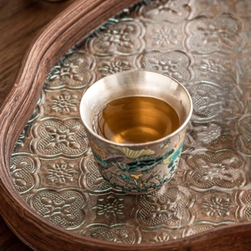 Artisan ceramic gongfu tea cup featuring fish and lotus symbolism, Buddhist-inspired design