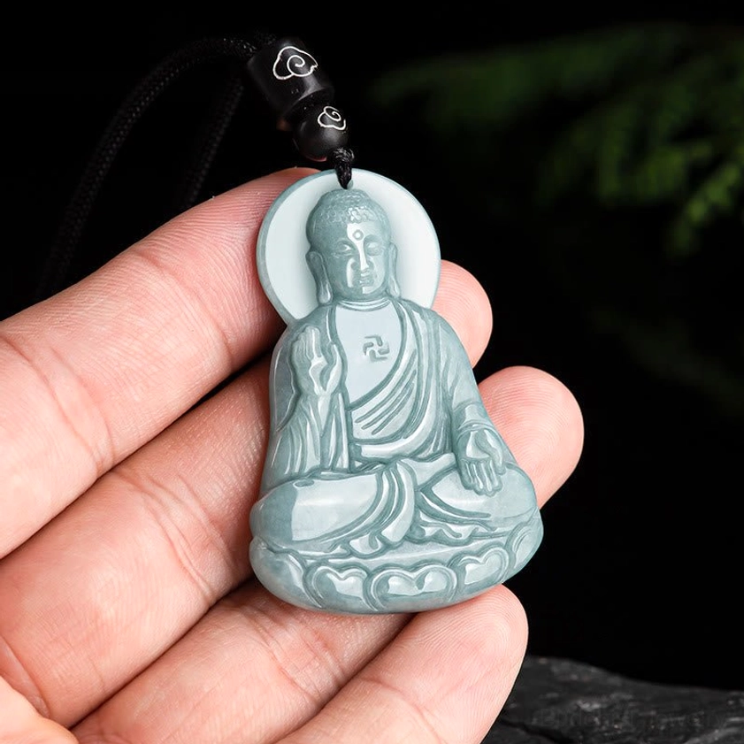 Amitabha Buddha jade pendant necklace held in hand showing portable size and light green jade color