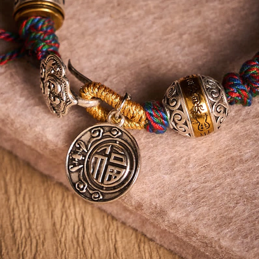 Handcrafted Buddhist Bracelet with Silver Accents and Woven Rope Texture