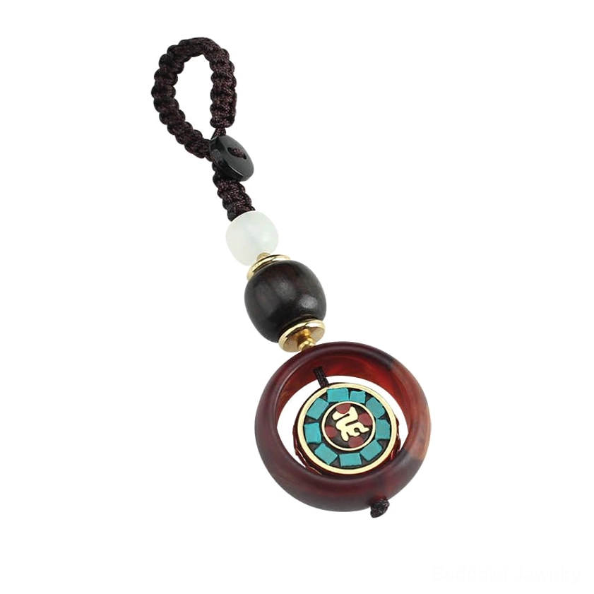 Flat lay product shot of rotating Buddhist keychain with braided cord and beads on clean white background