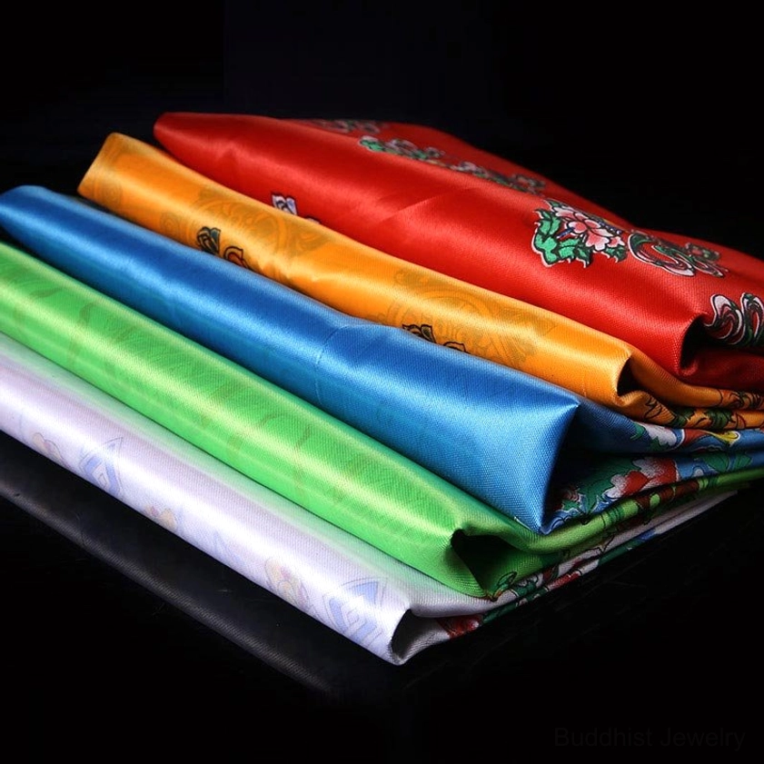 Set of 5 Buddhist khata scarves neatly stacked showing white, blue, yellow, green, and red plain satin fabric in premium quality