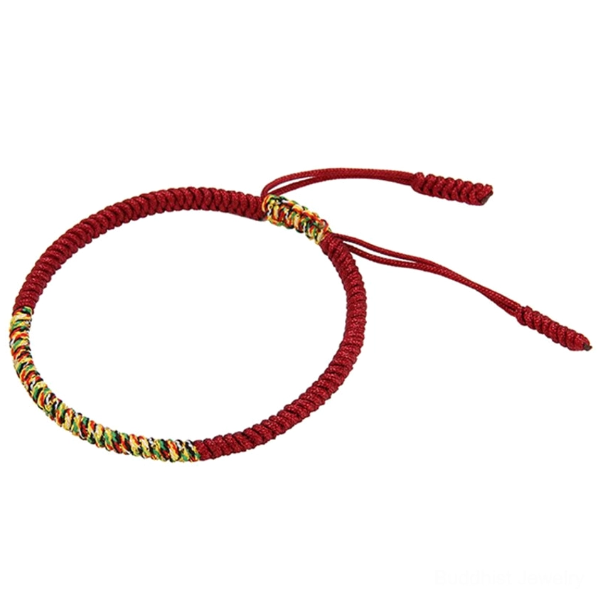 Single adjustable Buddhist King Kong Knot braided bracelet with deep red and multicolor woven section and dual rope tails on white background flat lay
