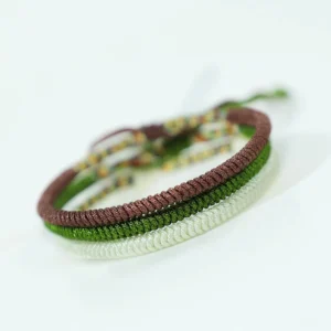 Handcrafted Buddhist King Kong Knot bracelet set featuring brown, white, and dark green braided cords with decorative spiritual knots for luck and protection