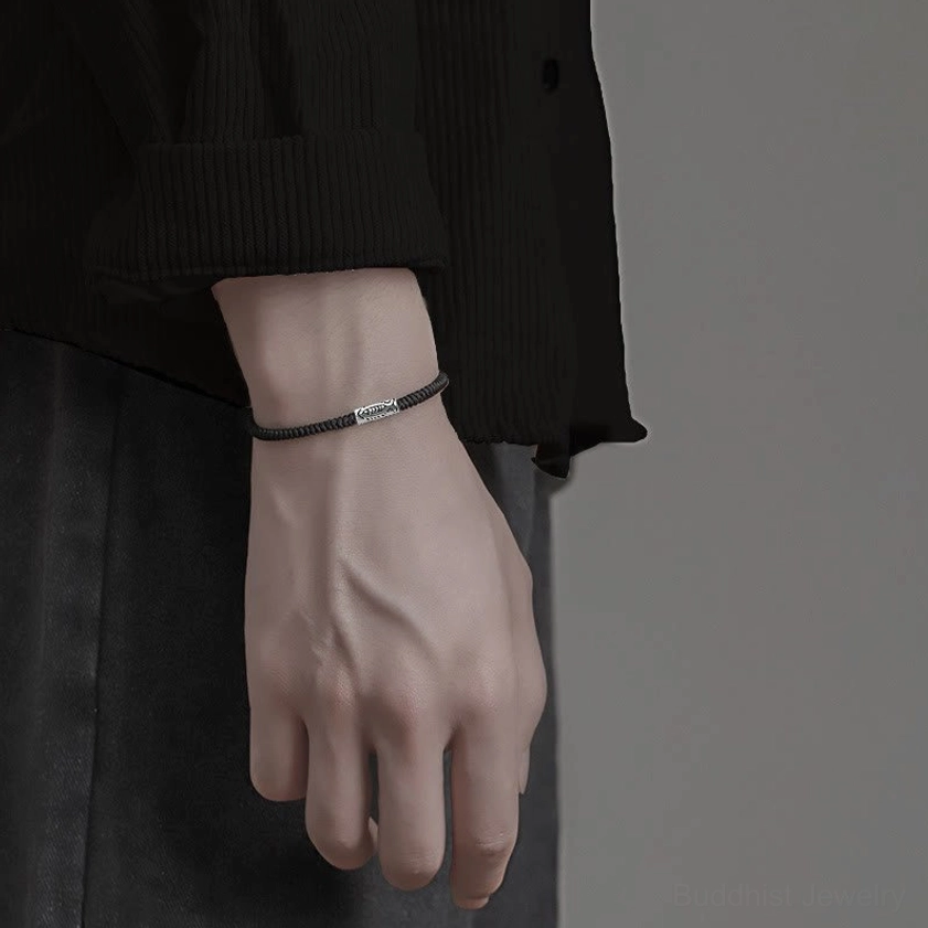 Koi fish bracelet worn under shirt cuff on male wrist showing neat placement with black shirt