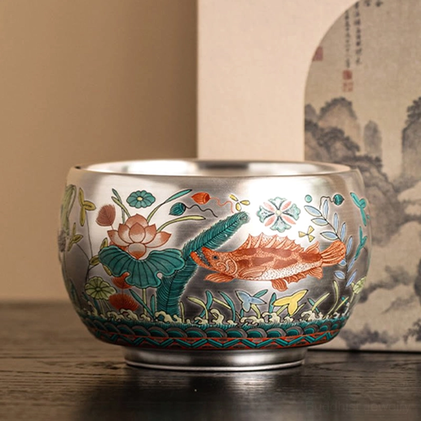 Buddhist tea ceremony cup with traditional landscape and floral-fish patterns on dark background, kung fu tea service
