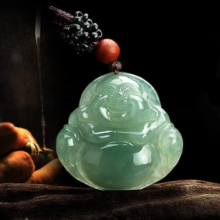 Classic Maitreya Buddha jade carving with red bead accent on wooden surface with gourd ornament props, traditional Buddhist pendant design