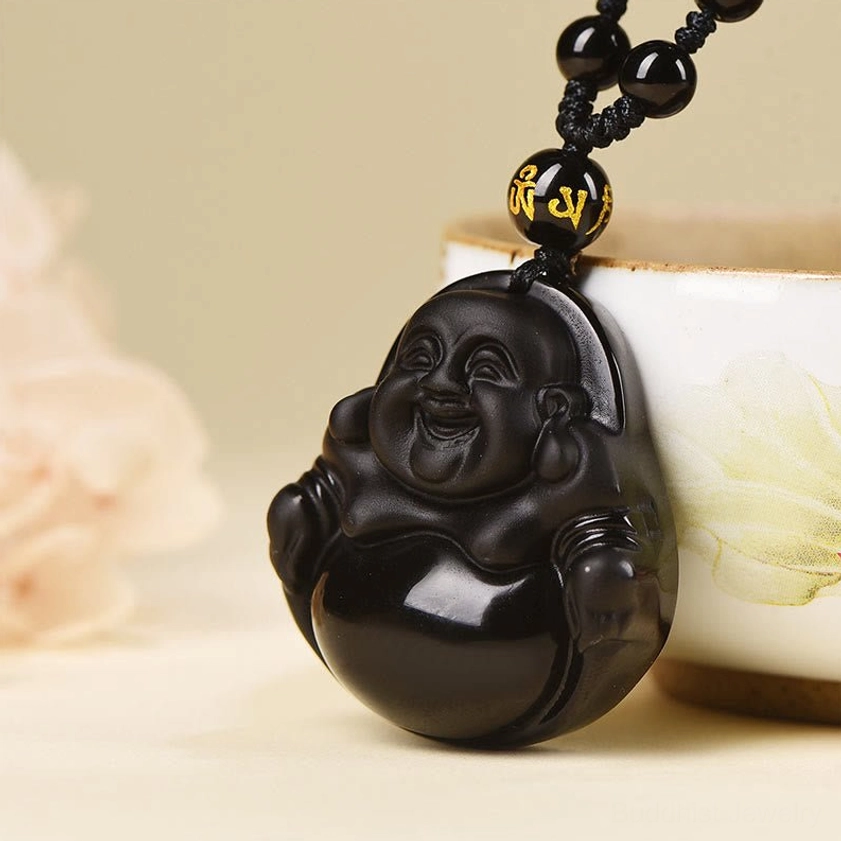 Buddhist pendant with traditional Laughing Buddha carving and natural obsidian stone texture