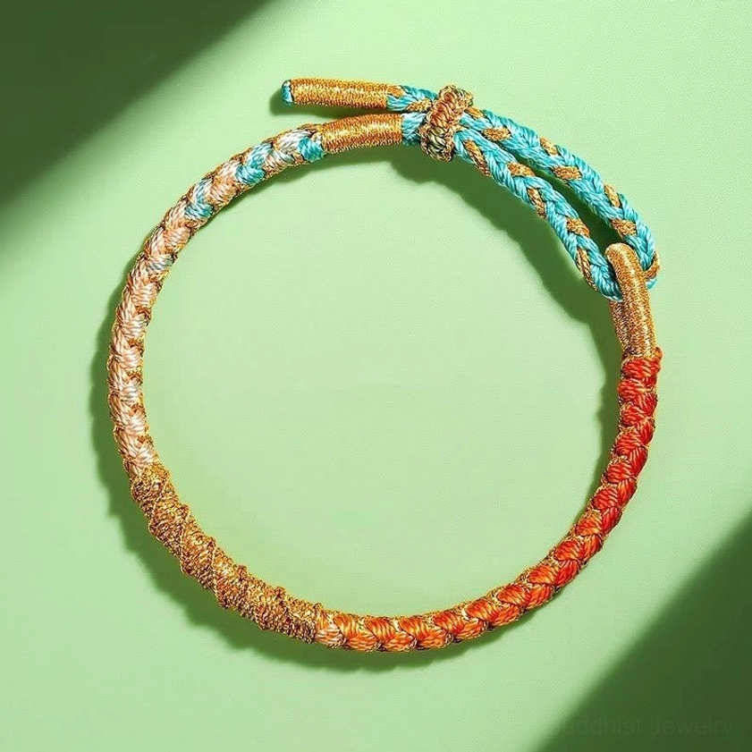 Light blue gradient Buddhist protection bracelet showing twisted scale texture handwoven braid pattern