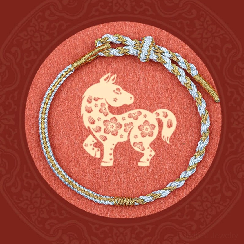 Light blue Buddhist red string bracelet featuring traditional braided protection cord design