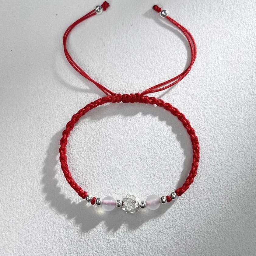Buddhist lotus cat's eye bracelet with red braided cord and milky white gemstone bead close-up detail