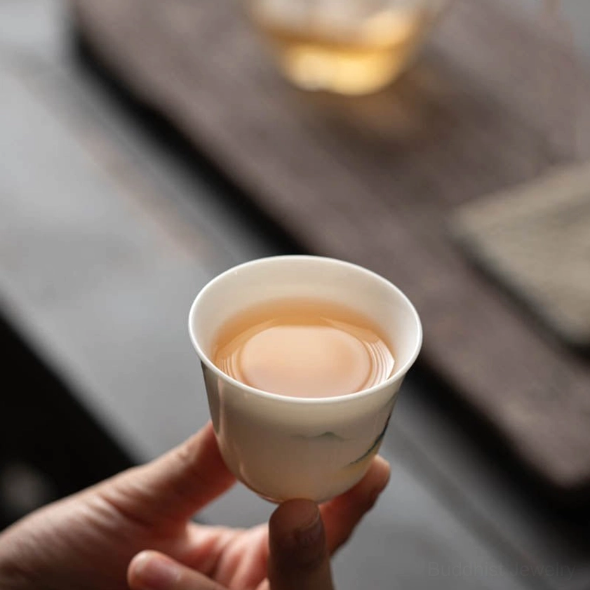 Handcrafted Buddhist ceramic kung fu tea cup with traditional hand-painted lotus flower design for meditation and mindfulness practice