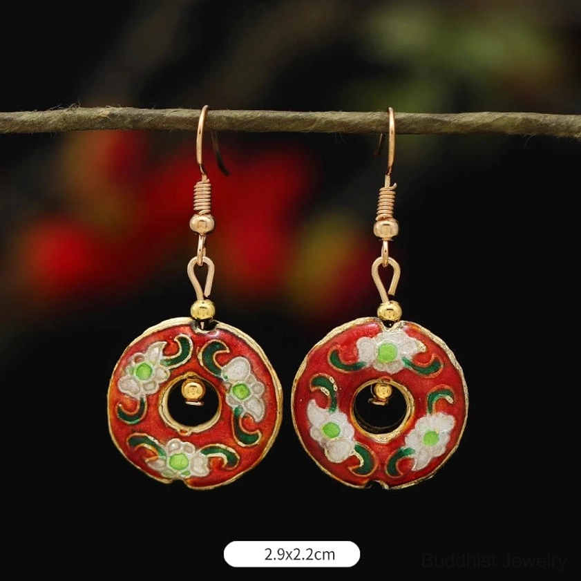 Multiple Buddhist enamel earring styles arranged showcasing diverse lotus and flower designs