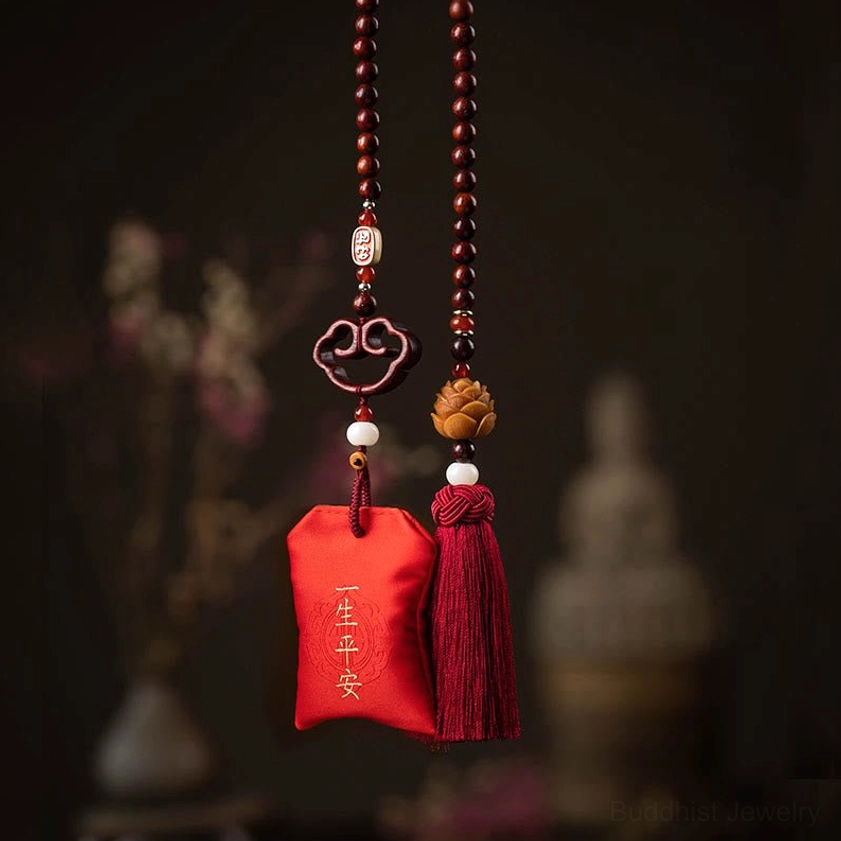 Buddhist lotus car hanging ornament with wooden lotus charm, red tassel, and life-long peace embroidery on dark vintage background