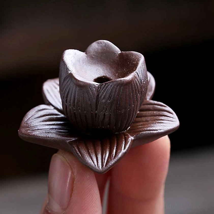 Handheld lotus incense insert with carved brown lotus design and matte ceramic finish