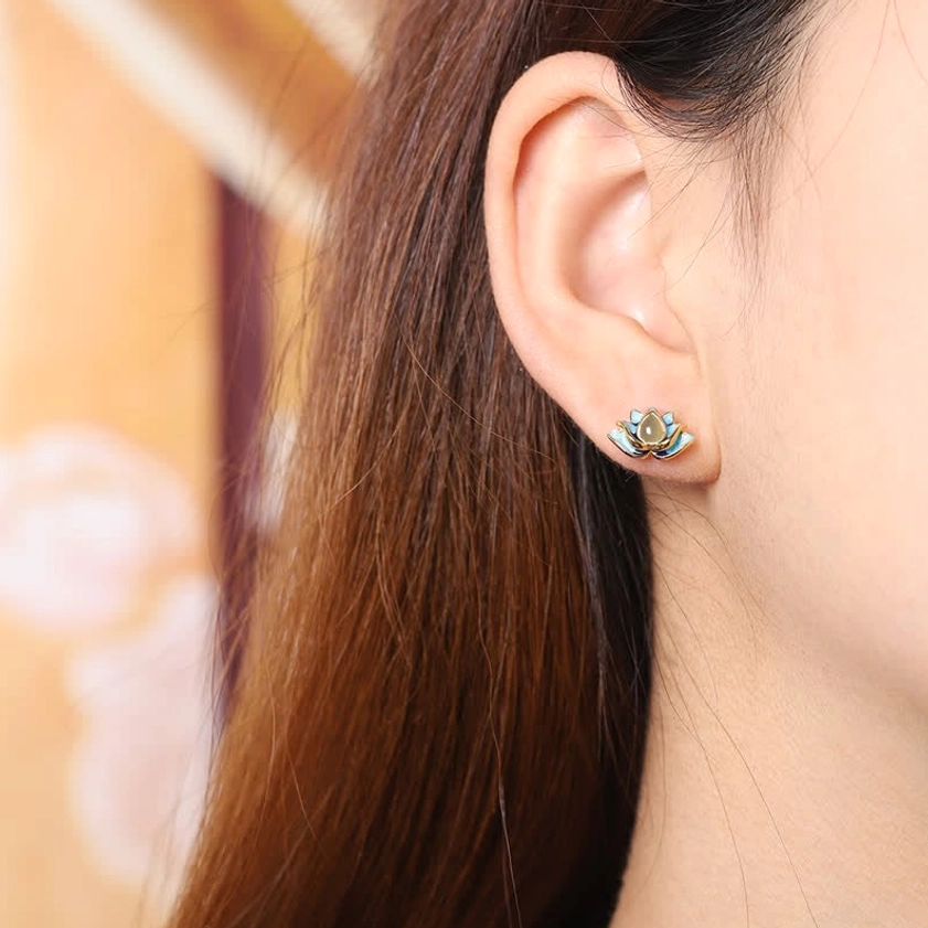 Lotus jade stud earrings worn on ear close-up side view showing delicate jade and silver design