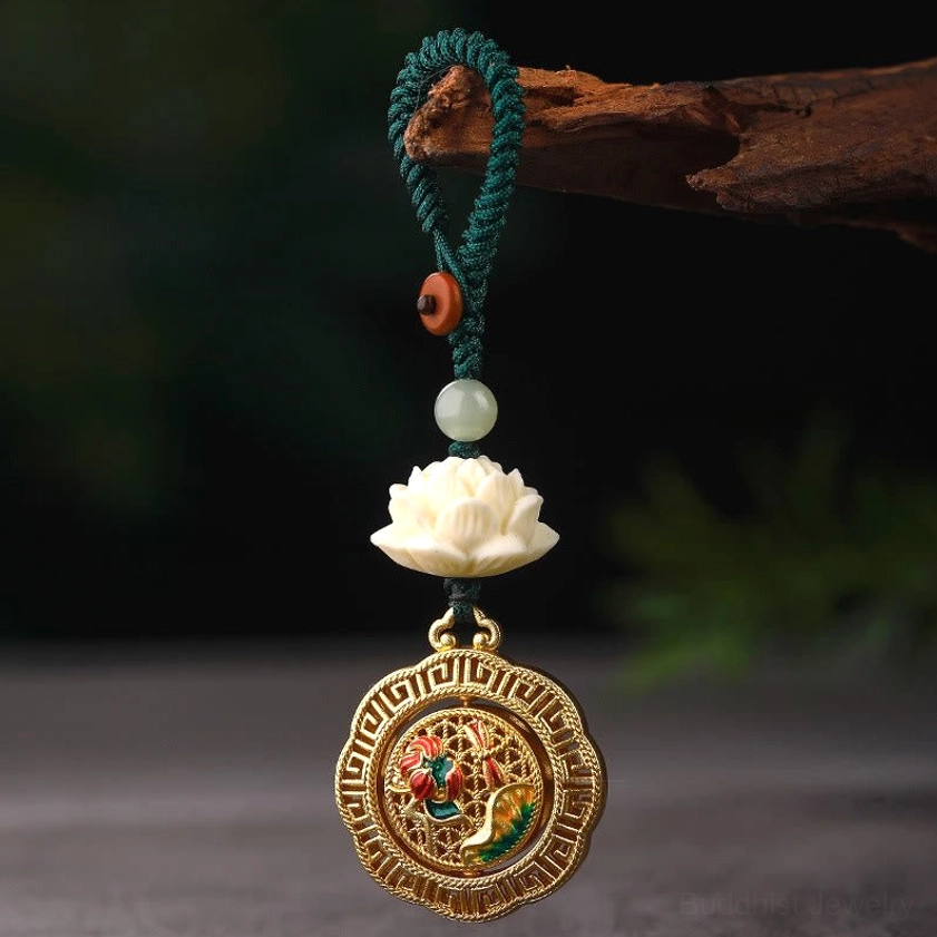 Buddhist charm keychain with green braided rope, wooden button detail, and rotatable lotus enamel pendant on wooden branch