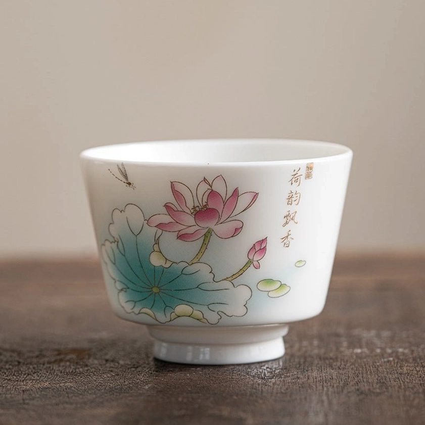 Authentic Buddhist ceramic tea cup featuring sacred lotus flower and lotus leaf imagery, hand-painted by skilled artisans