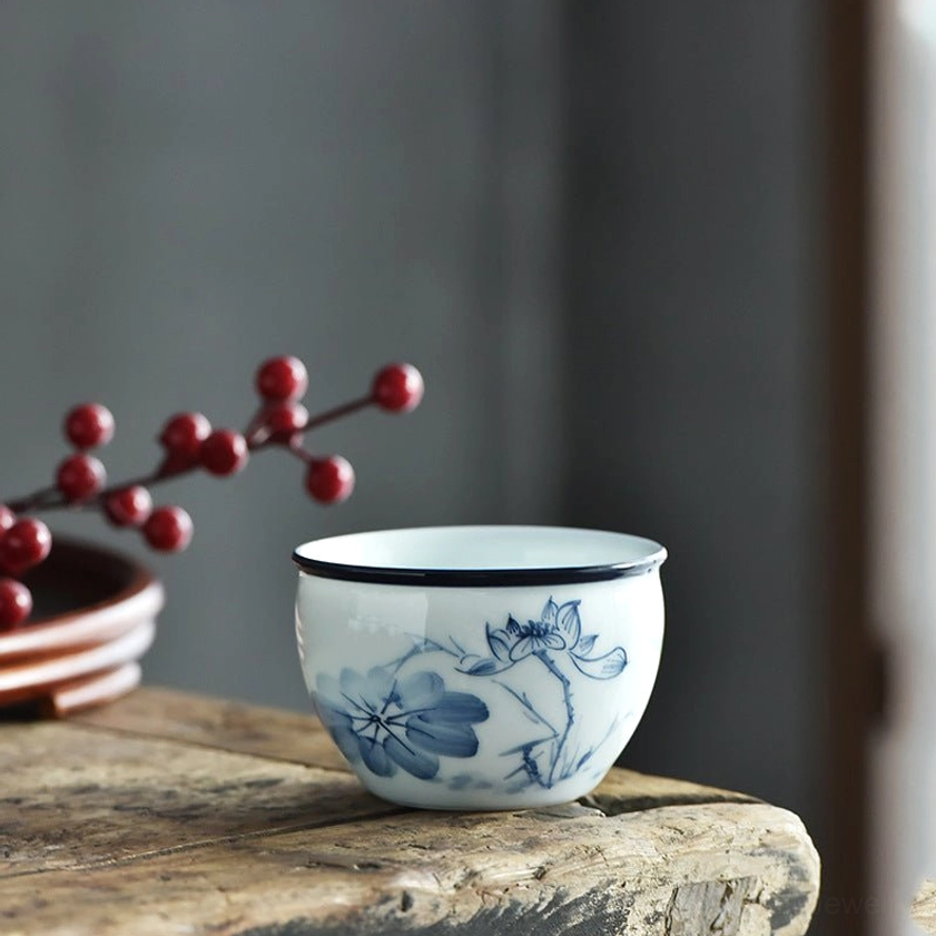 Ceramic tea cup with lotus leaf and flower pattern, blue-and-white porcelain Buddhist iconography