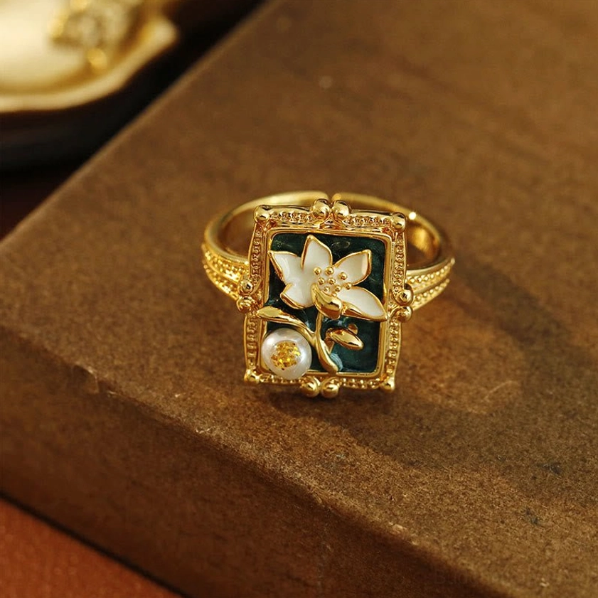 Adjustable lotus pearl ring front view - carved floral border and enamel lotus setting with cultured pearl center detail