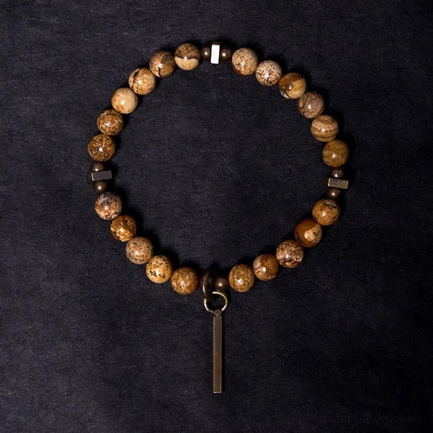 Round beaded Buddhist prosperity bracelet with antique copper hardware and stone beads overhead view