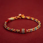Handmade Buddhist lucky string bracelet with colorful woven cords, multicolored protective rope with ethnic decorative knot and metal terminal bead