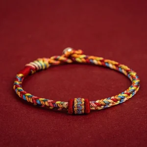 Handmade Buddhist lucky string bracelet with colorful woven cords, multicolored protective rope with ethnic decorative knot and metal terminal bead