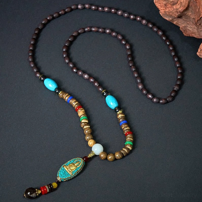 Buddhist prayer mala with dark wooden beads, turquoise spacers and Avalokitesvara Buddha charm pendant