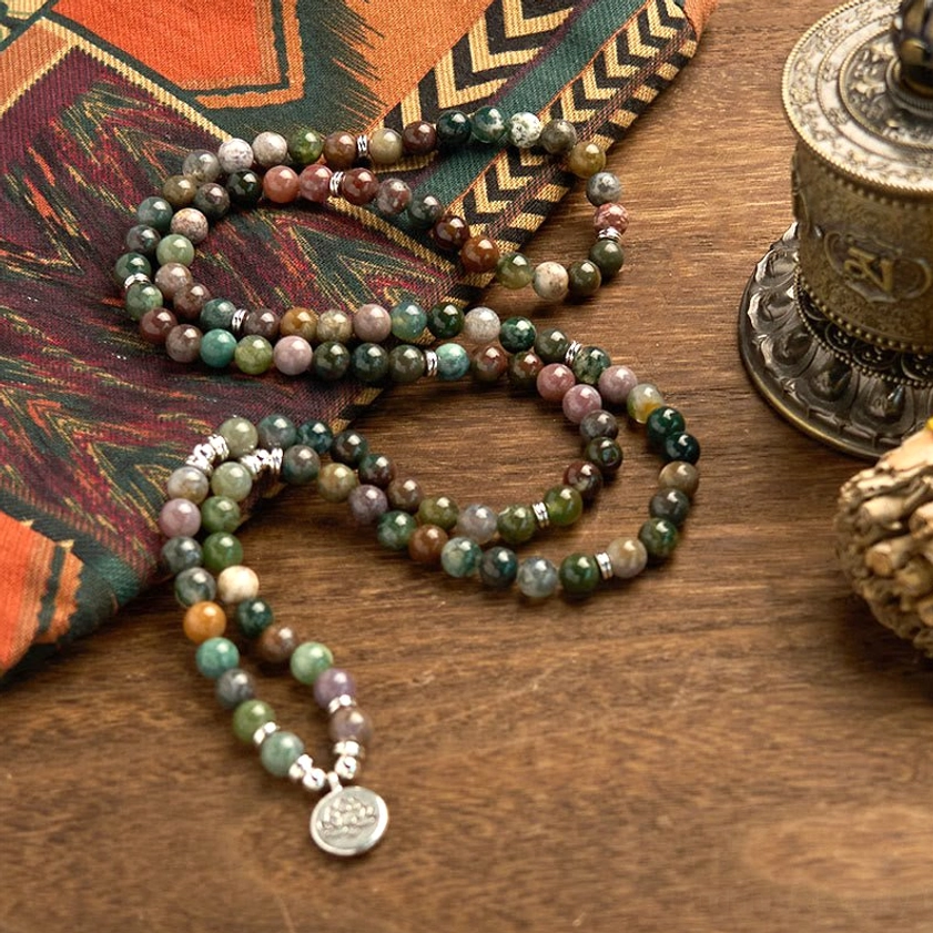 Prayer mala bracelet with 108 Indian agate beads, lotus charm pendant and accent stone beads on ethnic background