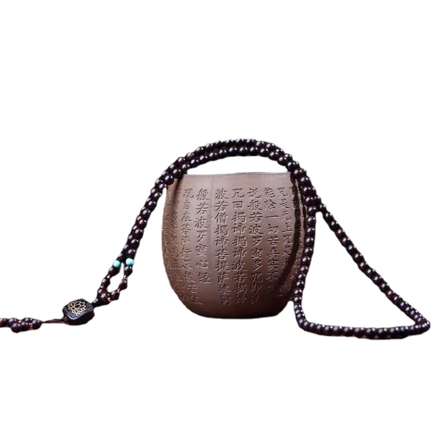 Buddhist prayer mala bracelet detail shot highlighting craftsmanship and sacred lotus symbol