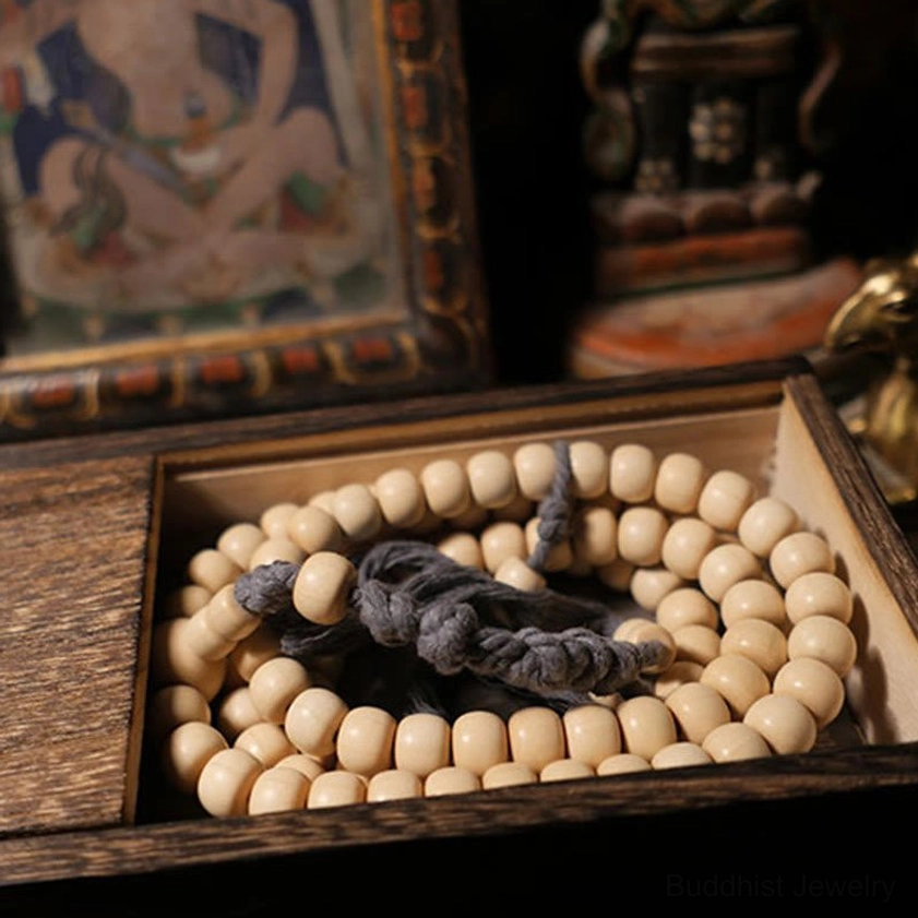 Complete Abelia Biflora 108 bead prayer mala bracelet neatly arranged in wooden storage display box