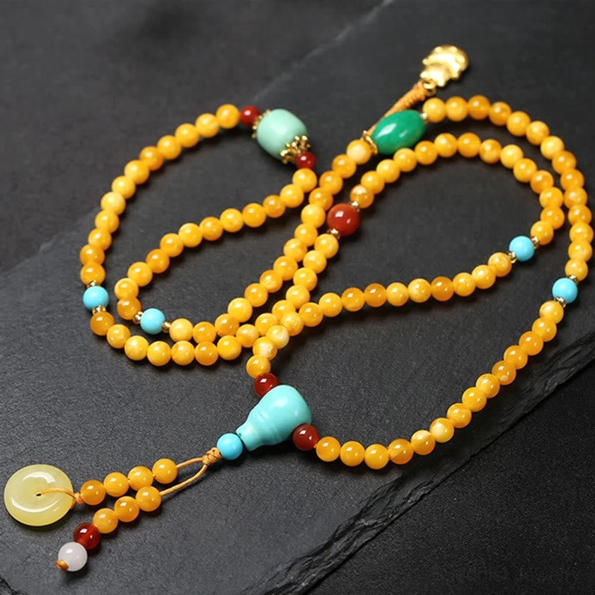 Buddhist prayer mala with amber beads, turquoise gourd-shaped guru bead, jade peace buckle pendant, and gold charm