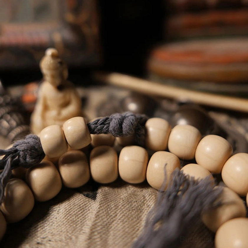 Macro close-up of uniform creamy Abelia Biflora wooden beads from Buddhist prayer mala bracelet